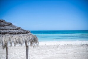On the beach, sun loungers, beach umbrellas