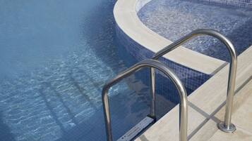 Seasonal outdoor pool, open 10:00 AM to 6:00 PM, pool umbrellas