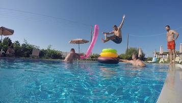 Seasonal outdoor pool, open 10:00 AM to 6:00 PM, pool umbrellas