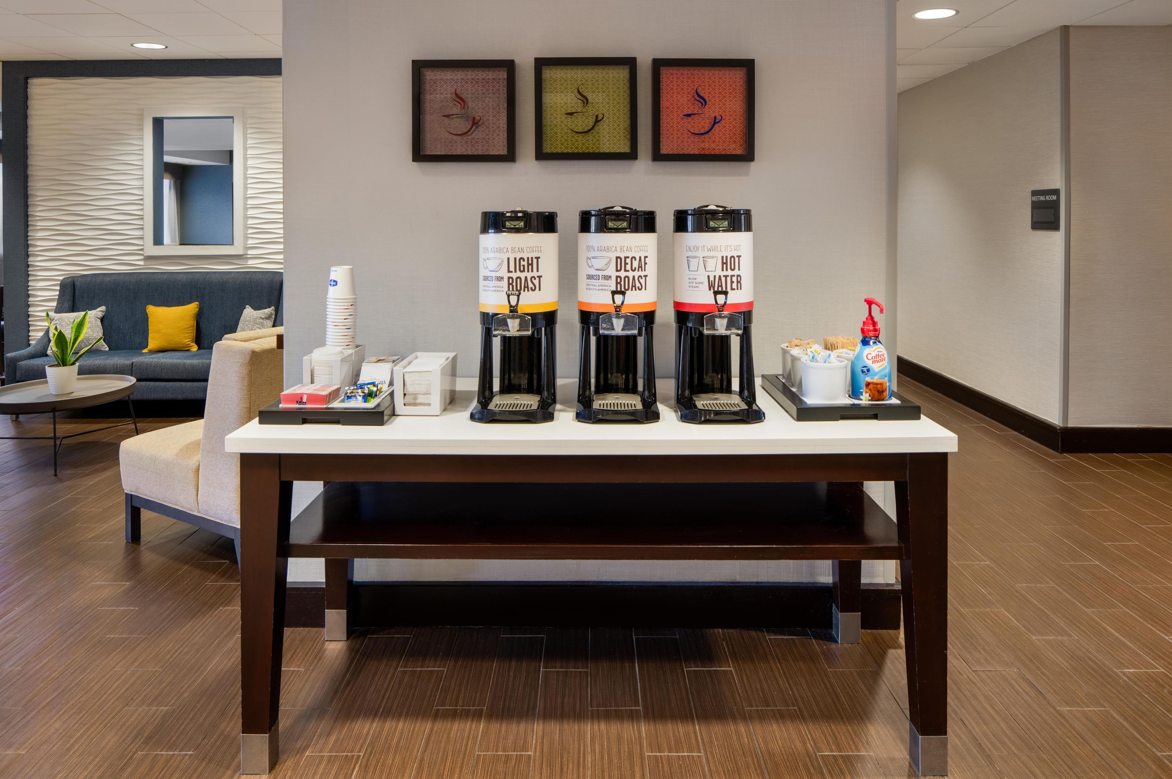 A coffee station with three coffee dispensers labeled "Light Roast," "Decaf," and "Hot Water."