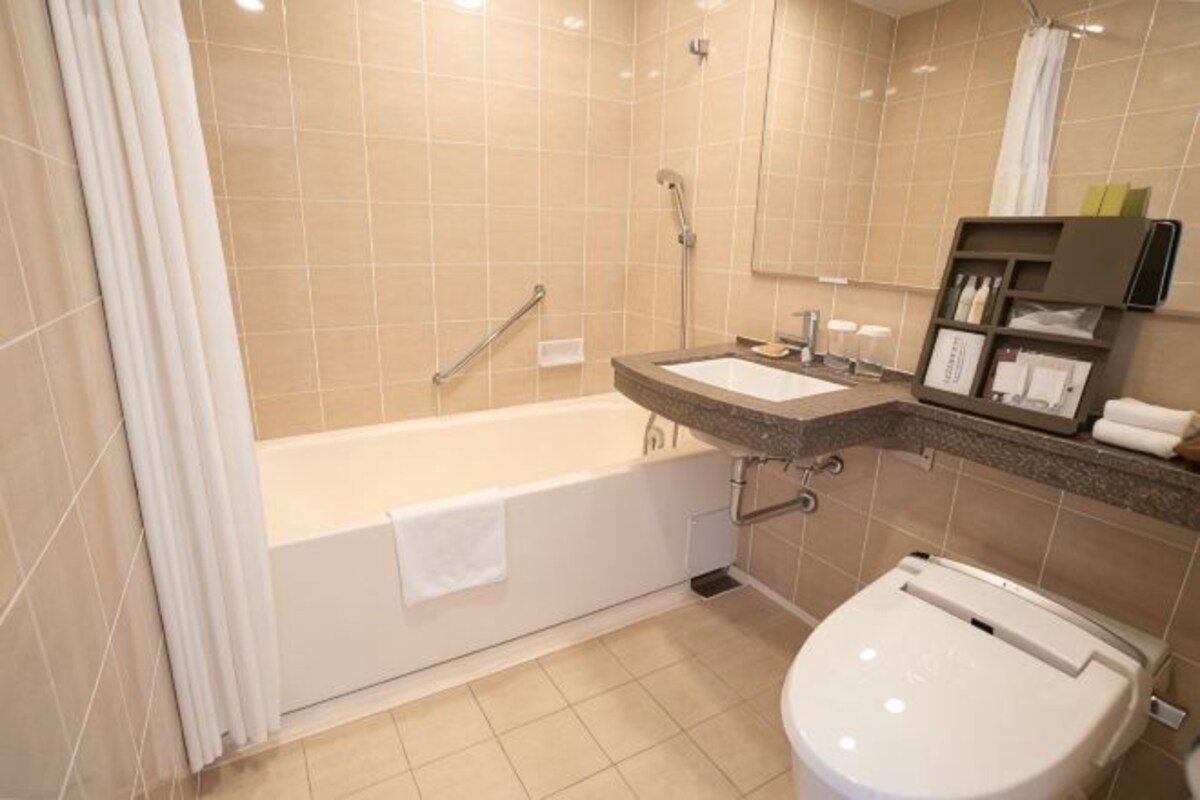 A bathroom with a bathtub, a toilet, a sink, and a shower.