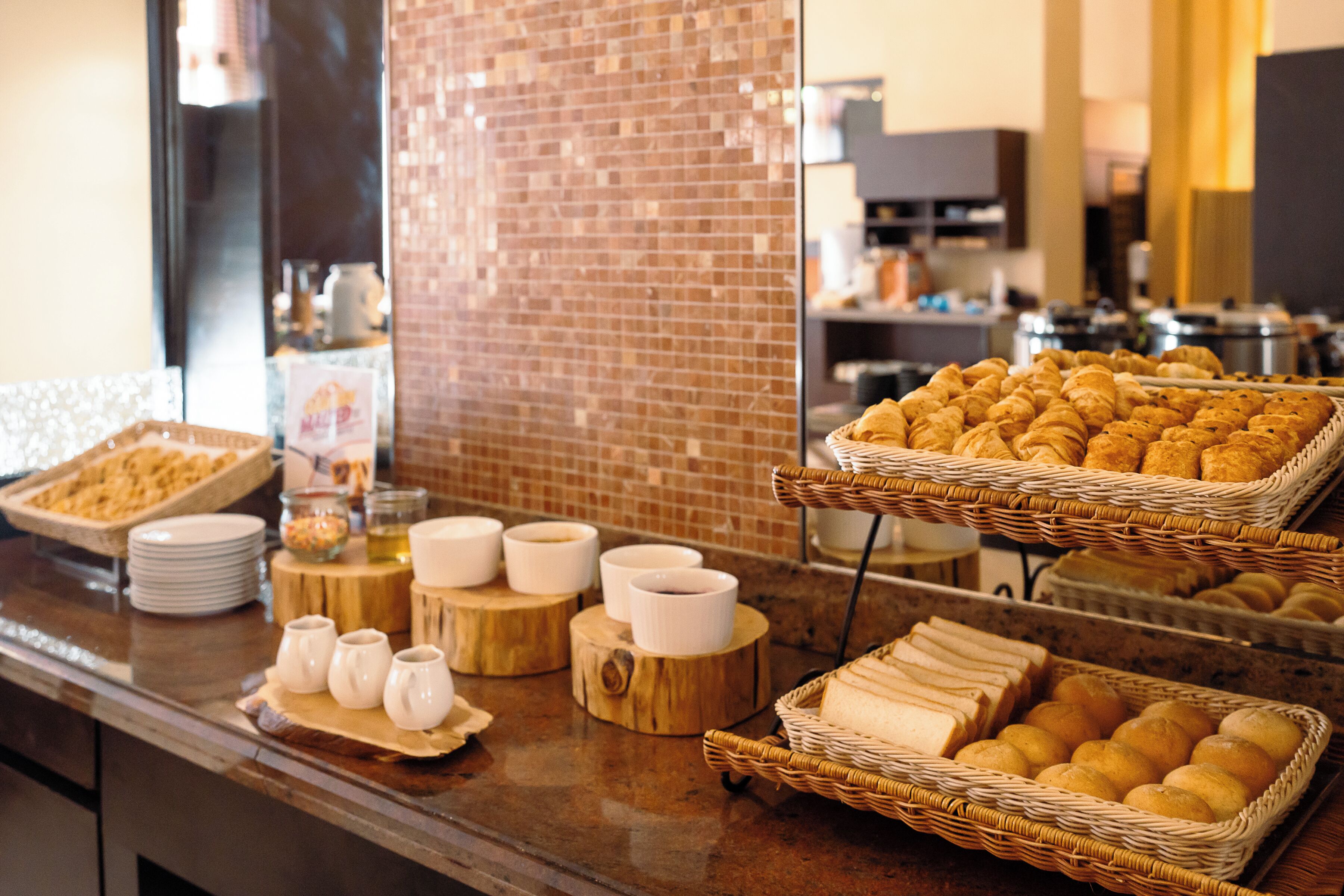 A buffet with various food items and serving ware.