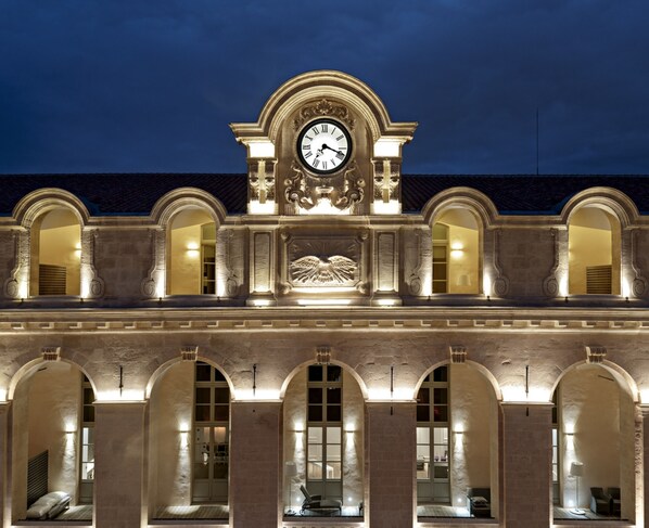 A historic building with a large clock, arched windows, and a central decorative element. - InterContinental Marseille - Hotel Dieu by IHG (Marseille)