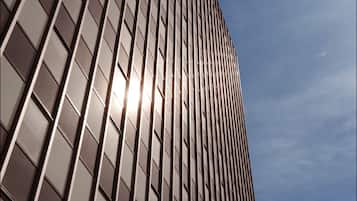 A tall building with a grid of windows and a clear sky.