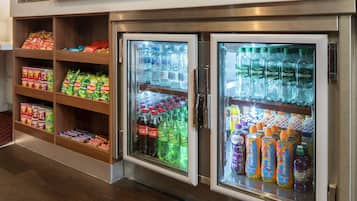 A refrigerated display case with various beverages and snacks.