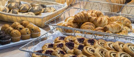 A bakery display with various baked goods including bread, muffins, and pastries.