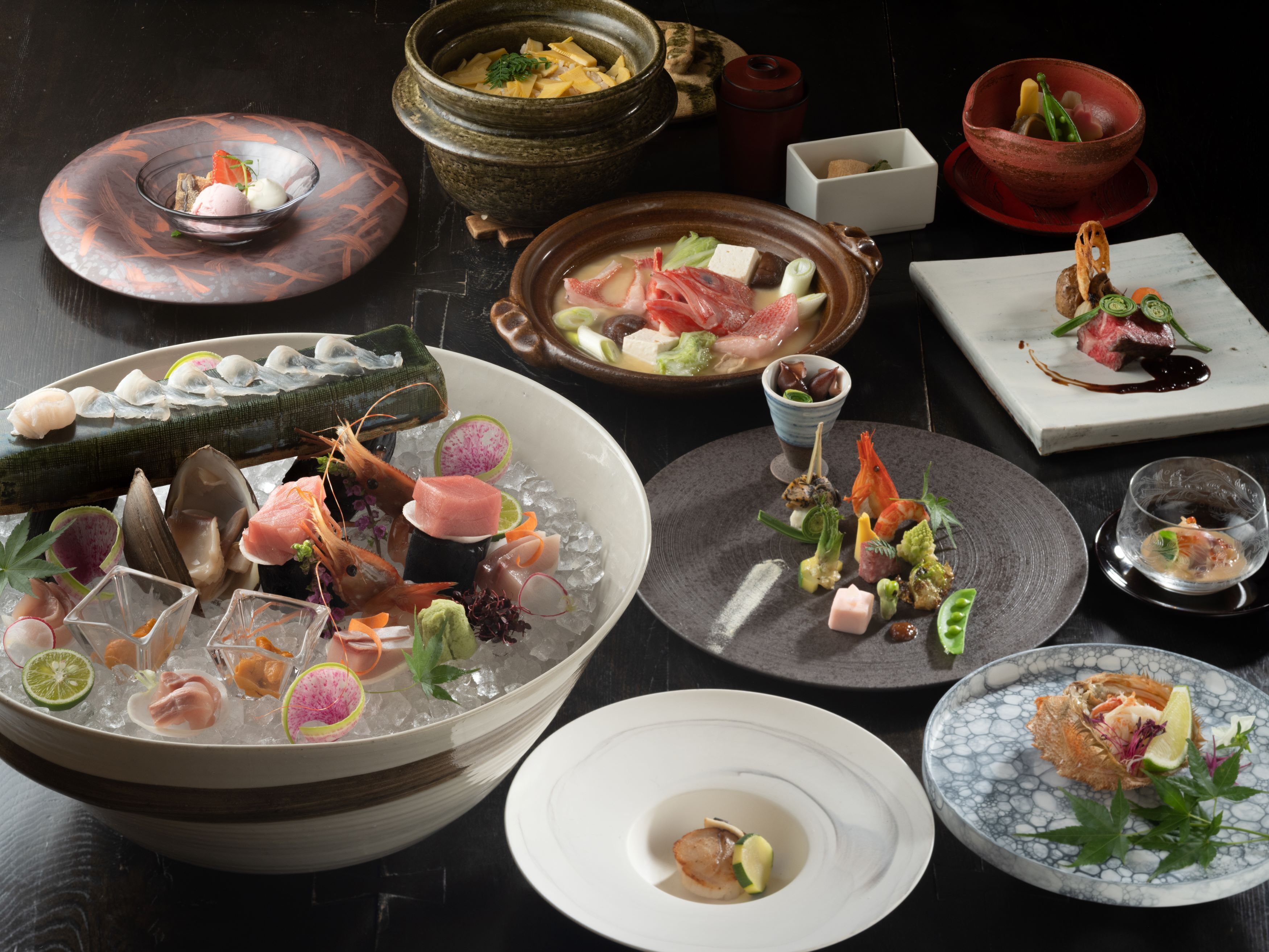 A variety of dishes including seafood, vegetables, and desserts, arranged on a table.