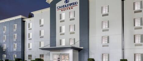A multi-story hotel with a prominent "Candlewood Suites" sign.
