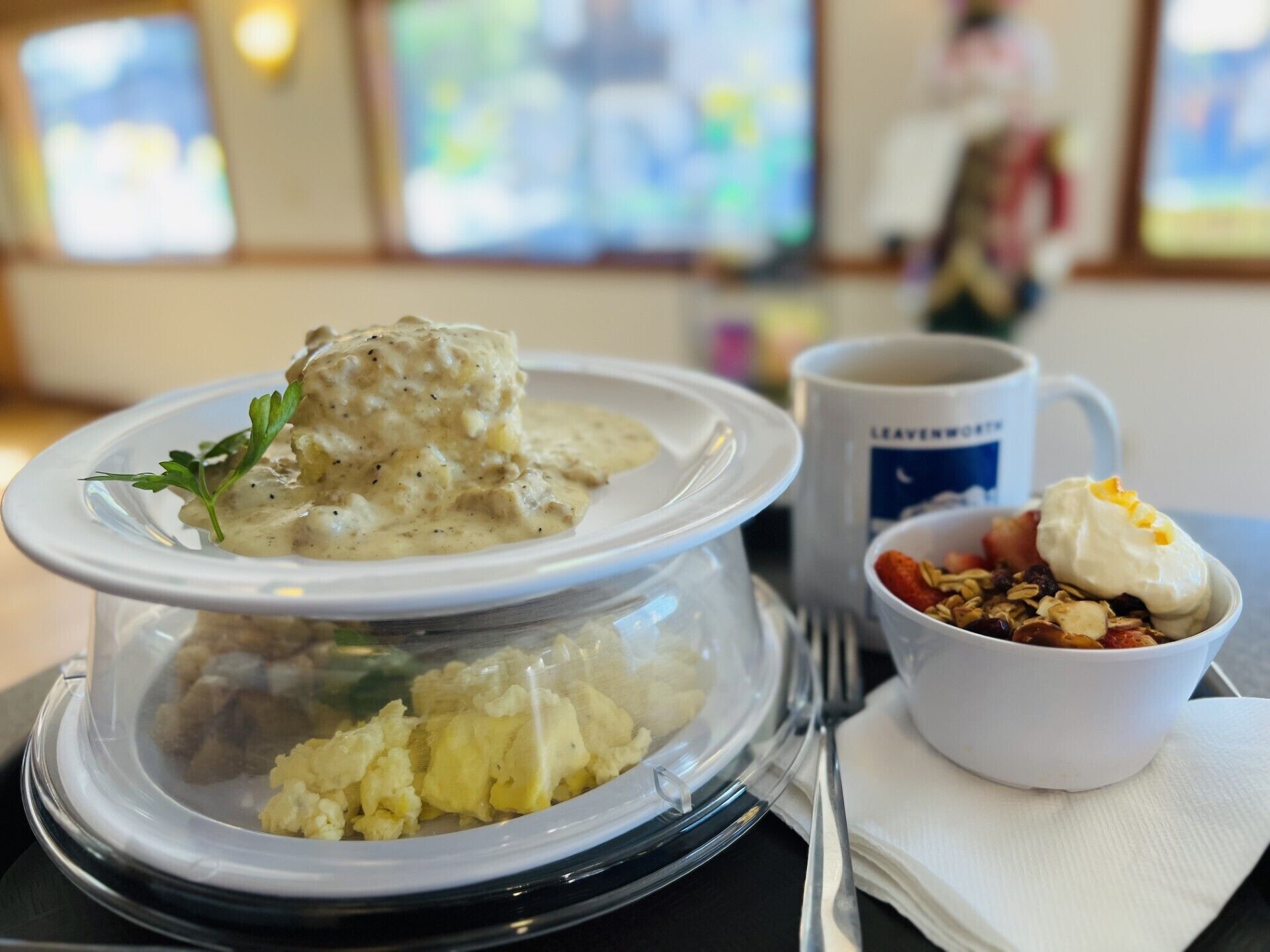 Un plato de huevos revueltos, un manjar cremoso, y un tazón de yogur con granola.