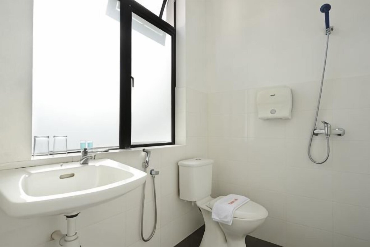 A bathroom with a sink, toilet, and shower.
