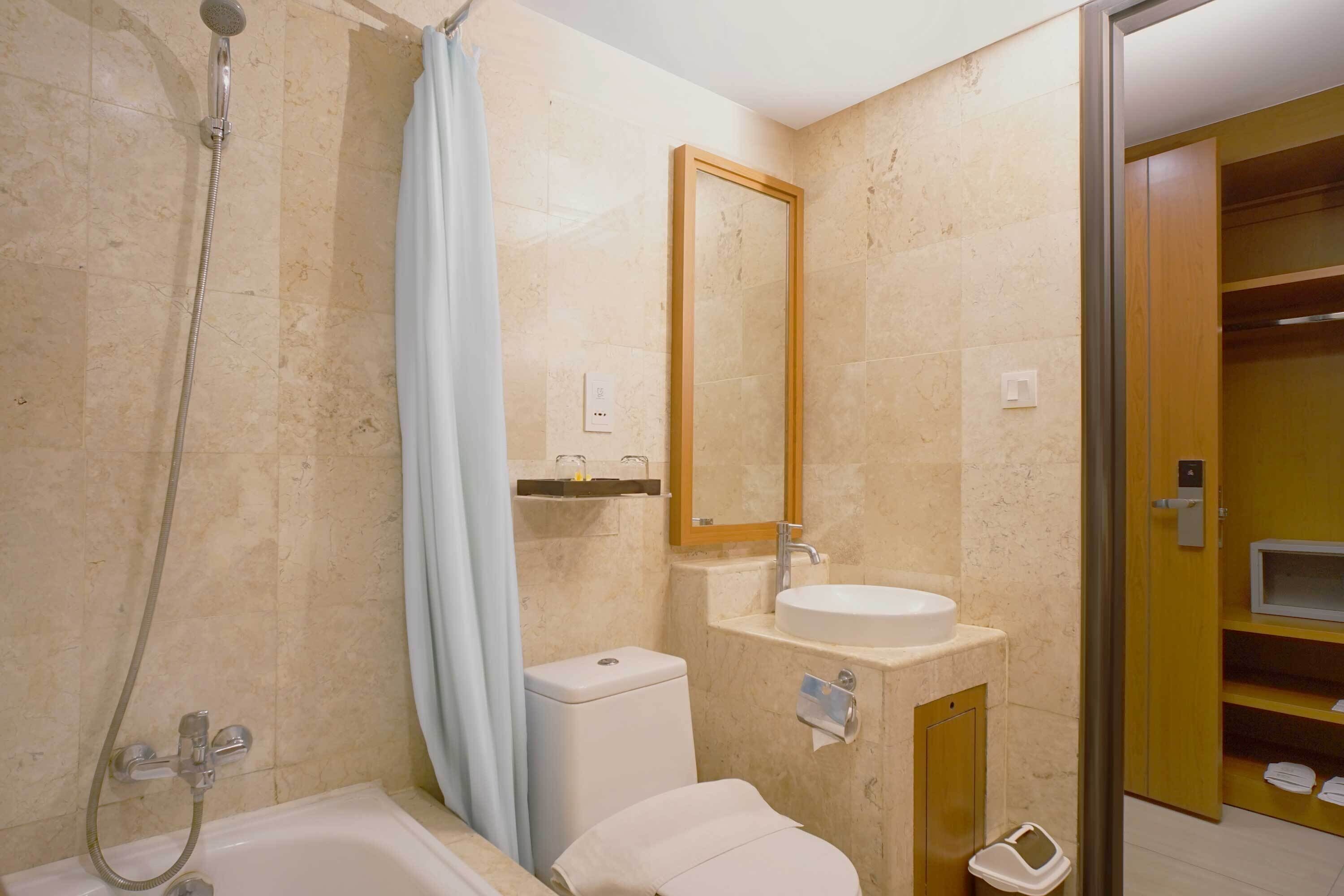 A bathroom with a bathtub, a toilet, a sink, and a shower.