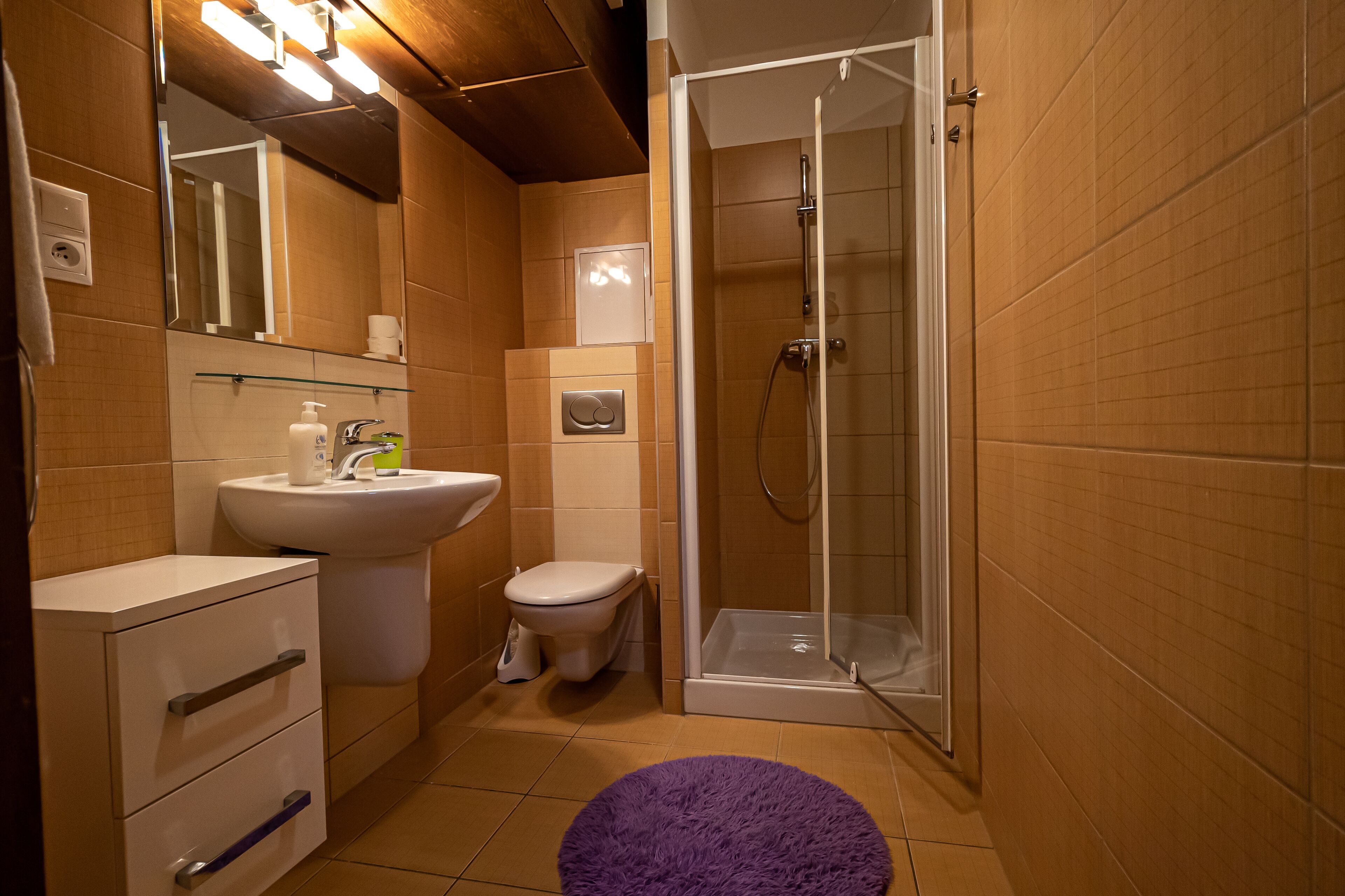 A bathroom with a sink, toilet, and shower.