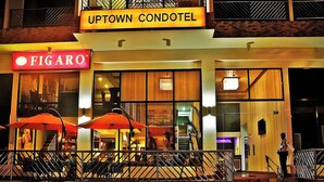The Uptown Condotel building with a visible Figaro sign and outdoor seating area. - Noorway Hotel and Residences (Cagayan de Oro)