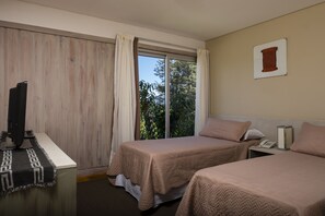 A hotel room with two beds, a desk with a computer, a telephone, and a window with curtains. - Bahía Montaña (Villa La Angostura)