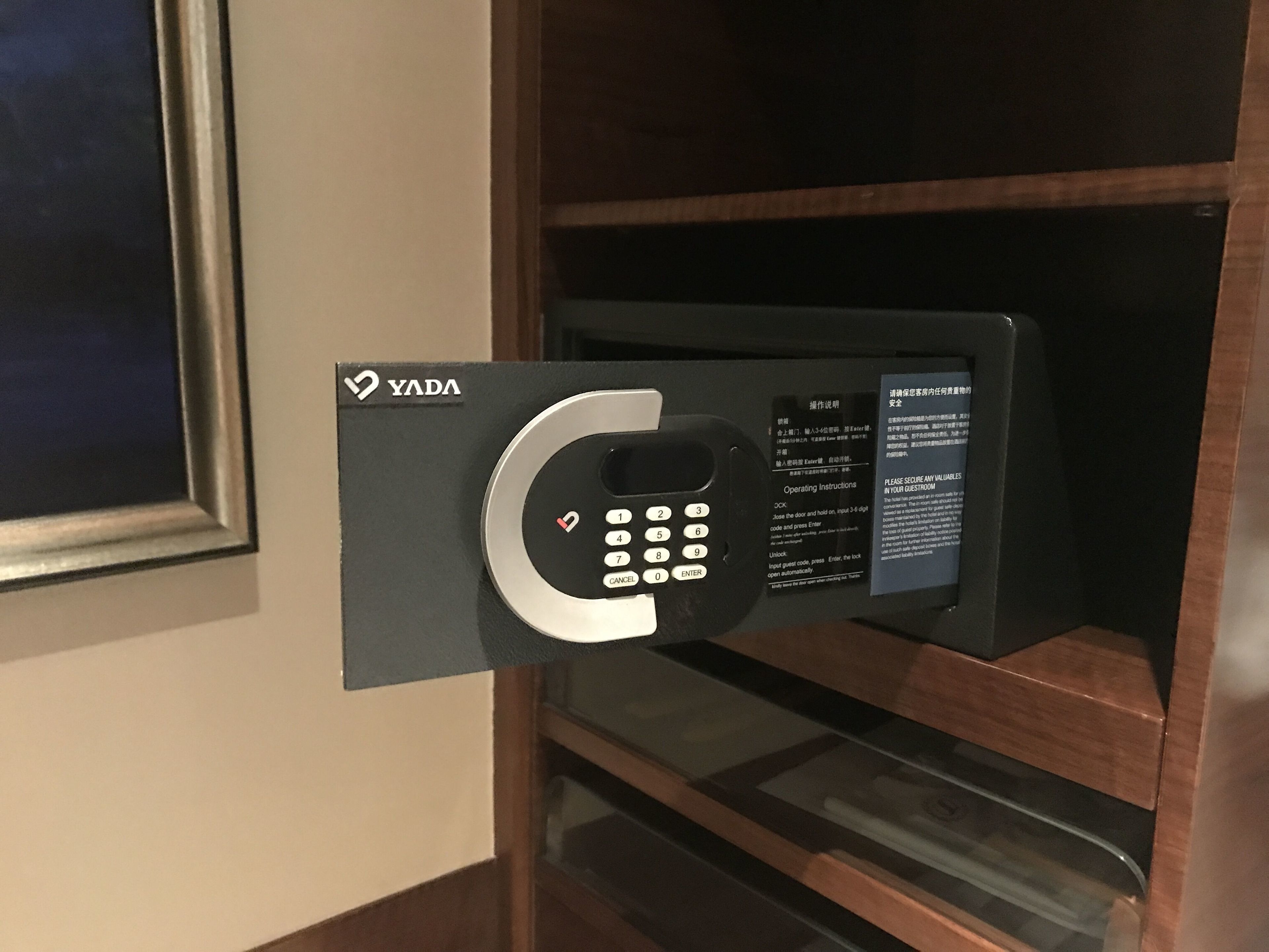 A YADA electronic lock on a door with operating instructions.