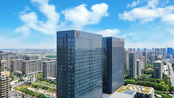 Standing tall in the heart of the city, this high-rise building offers stunning views of the urban landscape.