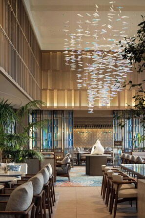 A spacious lobby with a high ceiling, modern furniture, and a central seating area. - Courtyard by Marriott Okinawa Resort (Nago)