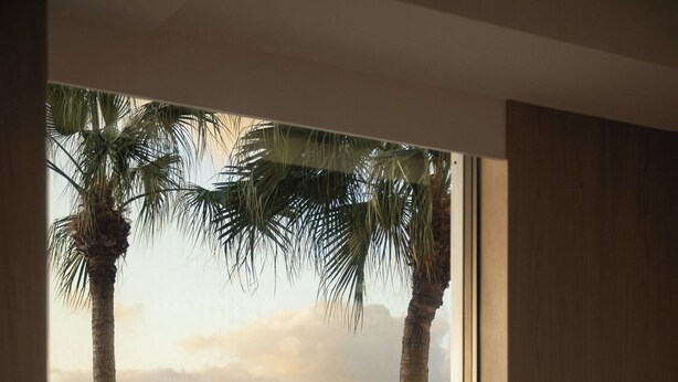 A room with a view of the sea, a round table, a chair, and a lamp. - Courtyard by Marriott Okinawa Resort (Nago)