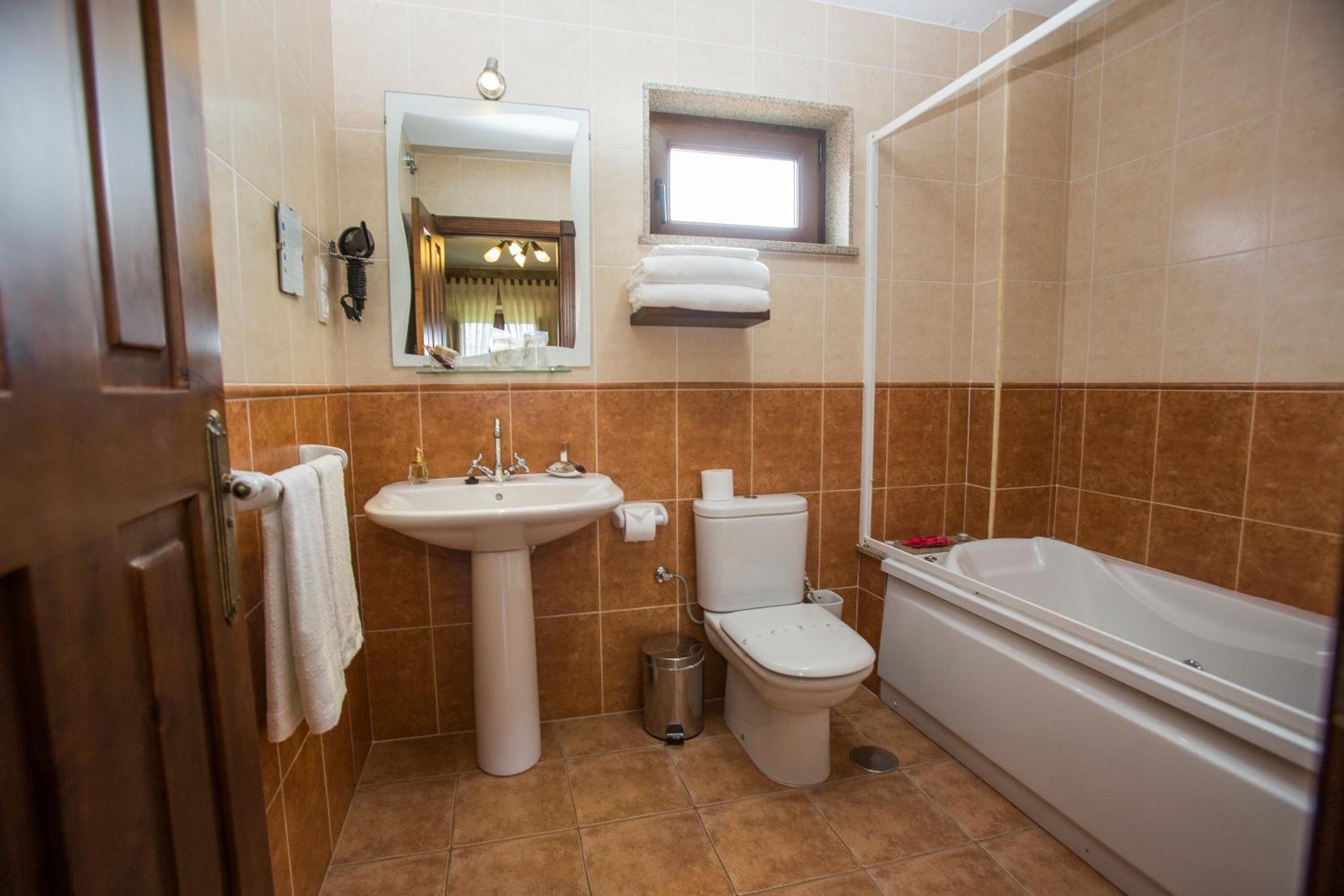 A bathroom with a sink, toilet, and bathtub.