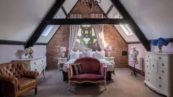 A bedroom with a sloped ceiling, a bed, a red chair, a dresser, and a mannequin.