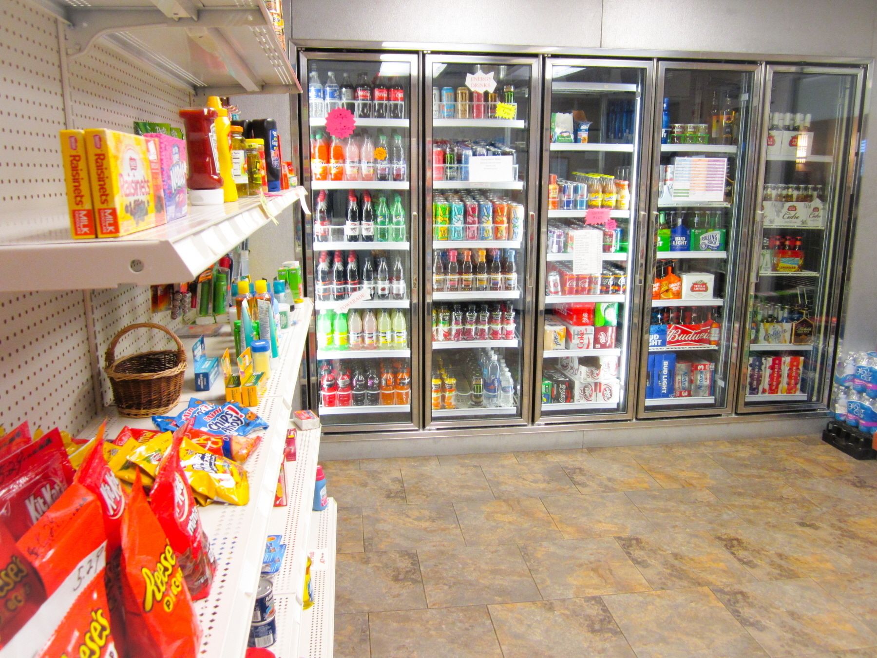 A grocery store with shelves stocked with snacks and beverages.
