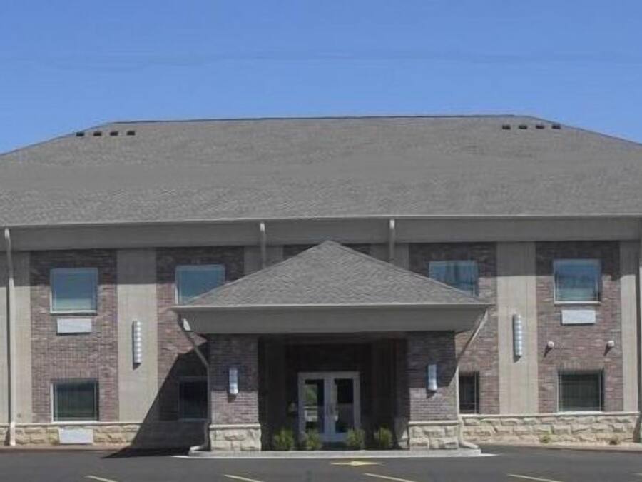 A large, two-story building with a flat roof and a central entrance.