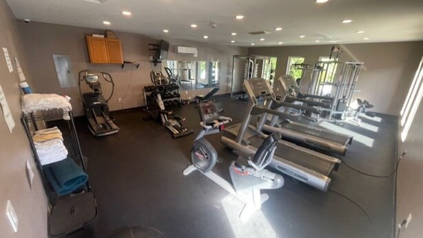 A gym with various exercise equipment, including treadmills, stationary bikes, and weight machines. - Bell's Extended Stay and Suites (St. Robert)