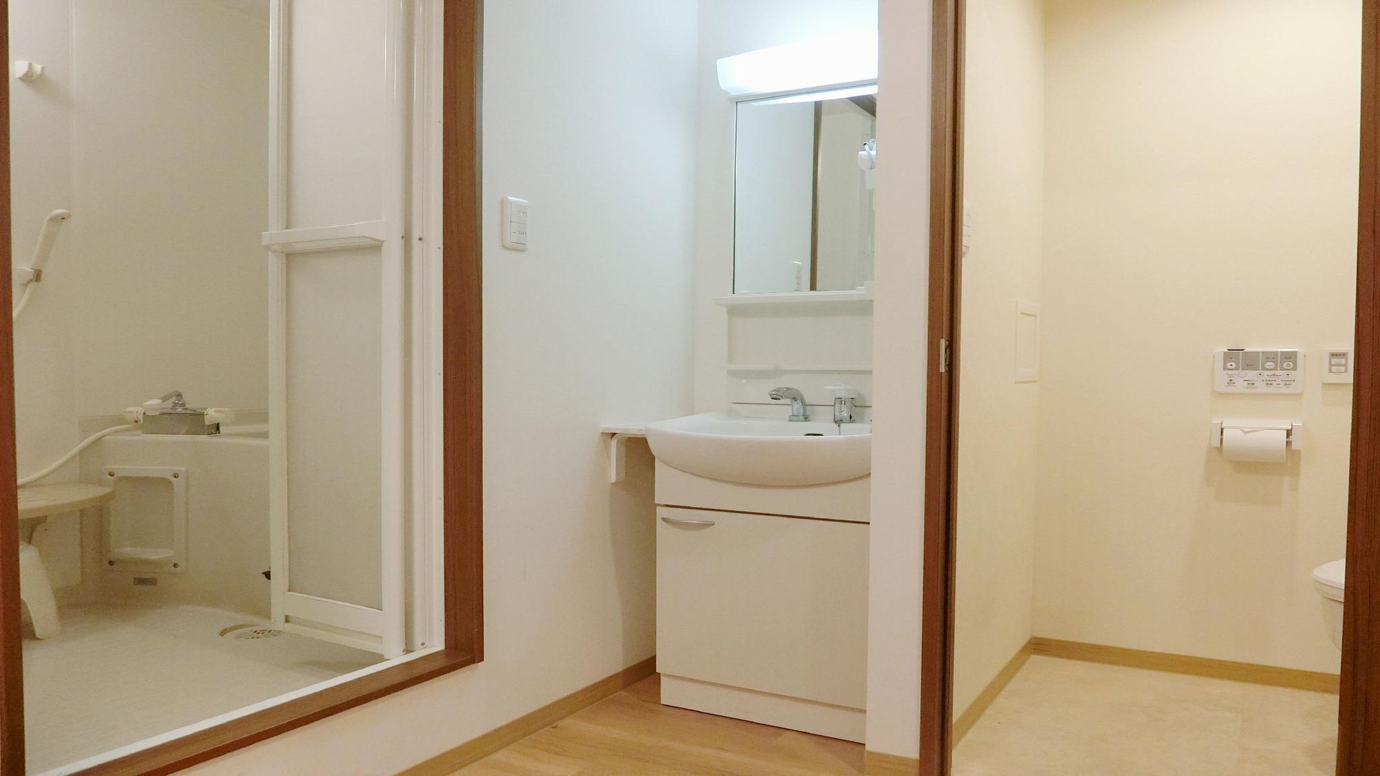 A bathroom with a shower, sink, and toilet.