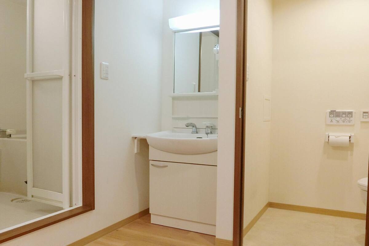 A bathroom with a shower, sink, and toilet.