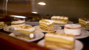 A display of various cakes on plates.