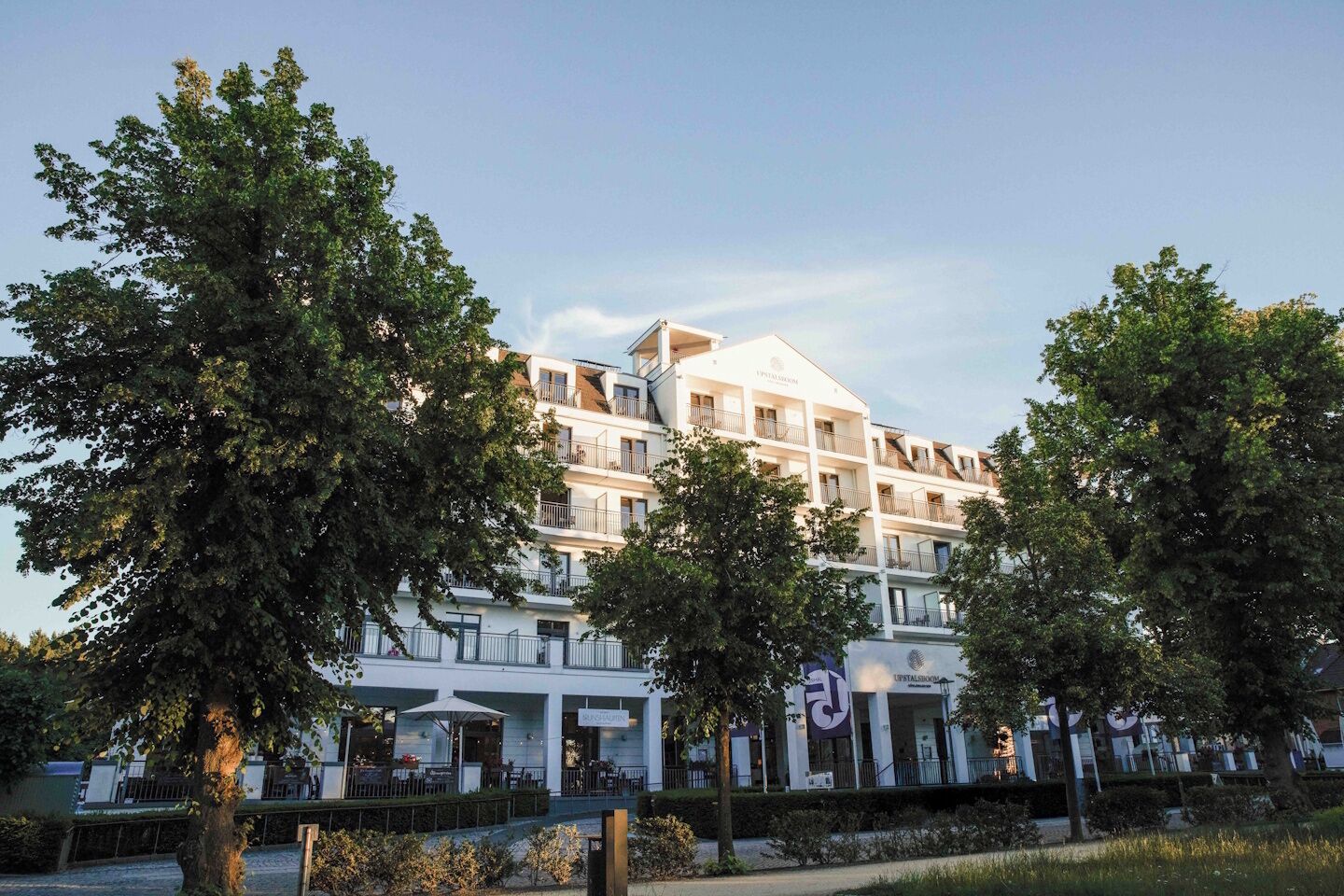 A multi-story hotel with balconies, a restaurant, and a spa.
