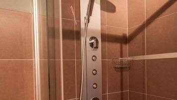 A modern shower with a rain showerhead, multiple control knobs, and a handheld showerhead.