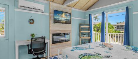A bedroom with a bed, desk, chair, and a TV on the wall.