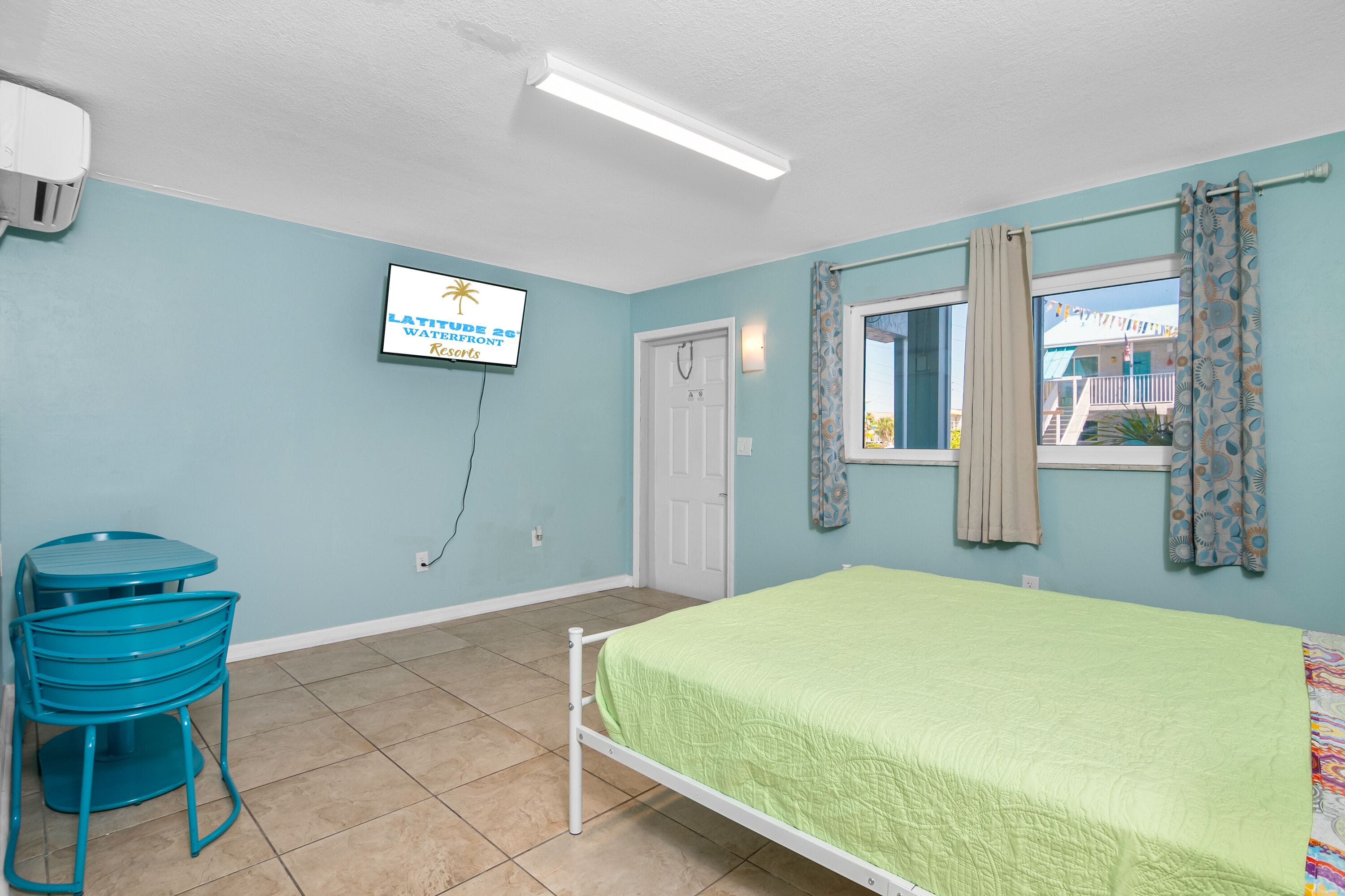 A room with a bed, a desk, and a chair.