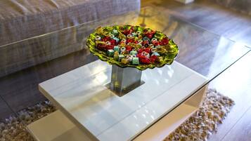 A glass coffee table with a decorative bowl on top.