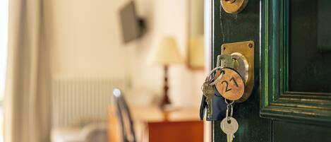 A door with a keyhole, a key, and a keychain with a padlock.