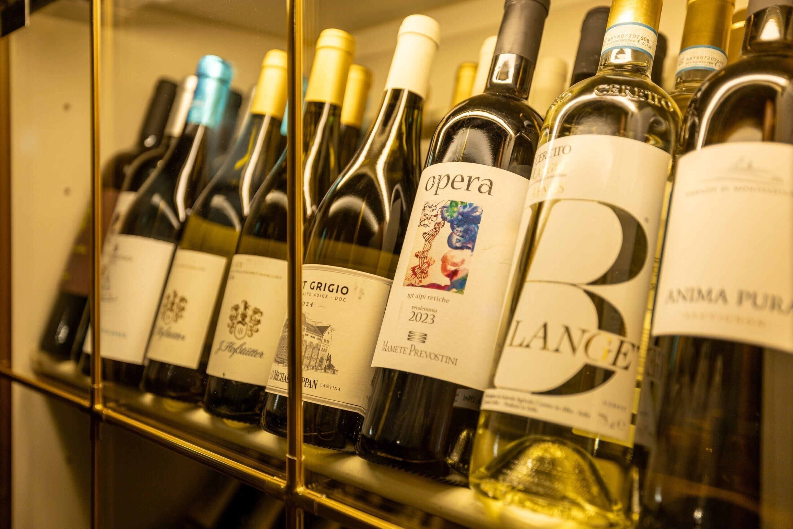 A collection of wine bottles on a shelf.