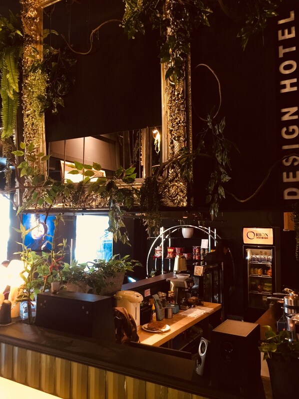 A bar area with a counter, bar stools, and a refrigerator labeled "Orion." - Orion Design Hotel (Kuala Lumpur)
