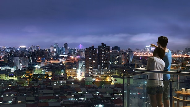 A cityscape view from a high-rise building at night.