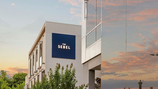 A modern building with a sign reading 'THE SEBEL' and a clear sky with clouds. - The Sebel Melbourne Kew (Kew)