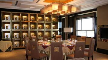 A dining area with a round table set for six, surrounded by chairs with a patterned design.