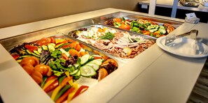 A buffet with various food options including salads, meats, and vegetables. - Mercure Kyiv Congress (Kyiv)