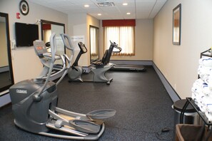 A fitness center with treadmills, elliptical machines, and a stationary bike.