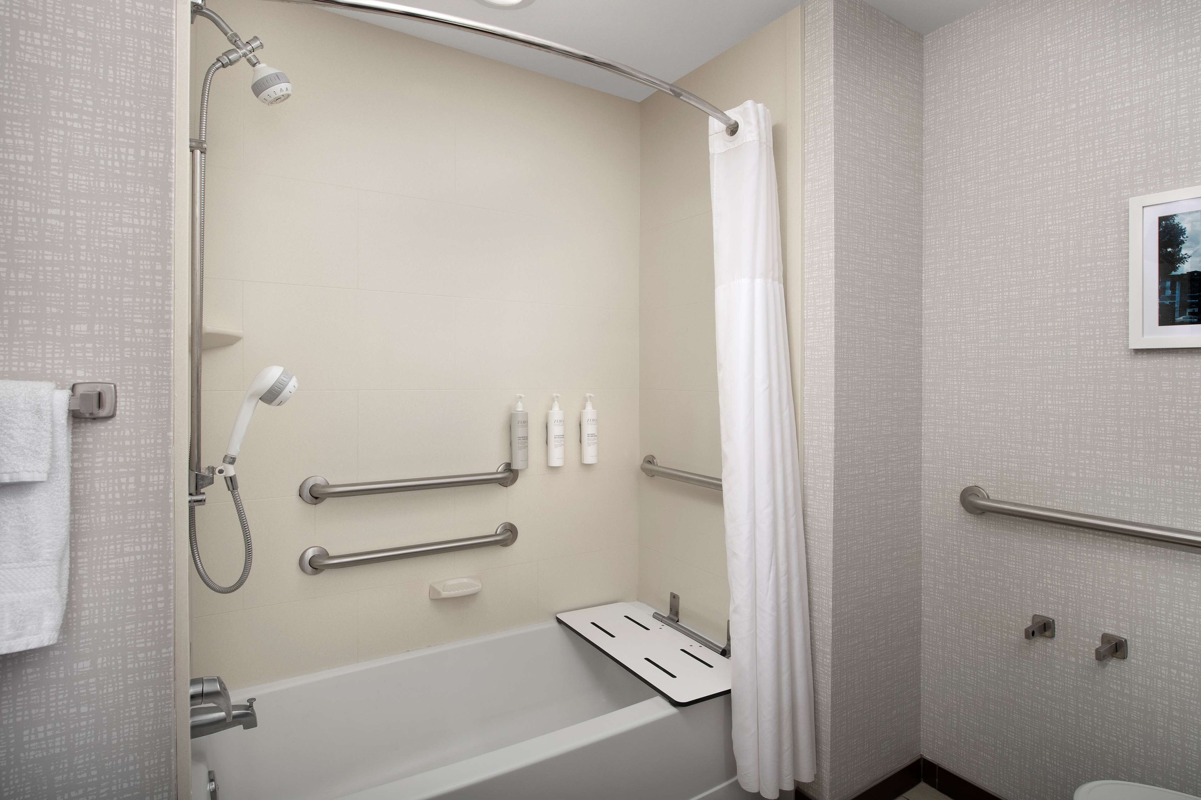 designer toiletries, hair dryer, towels, soap