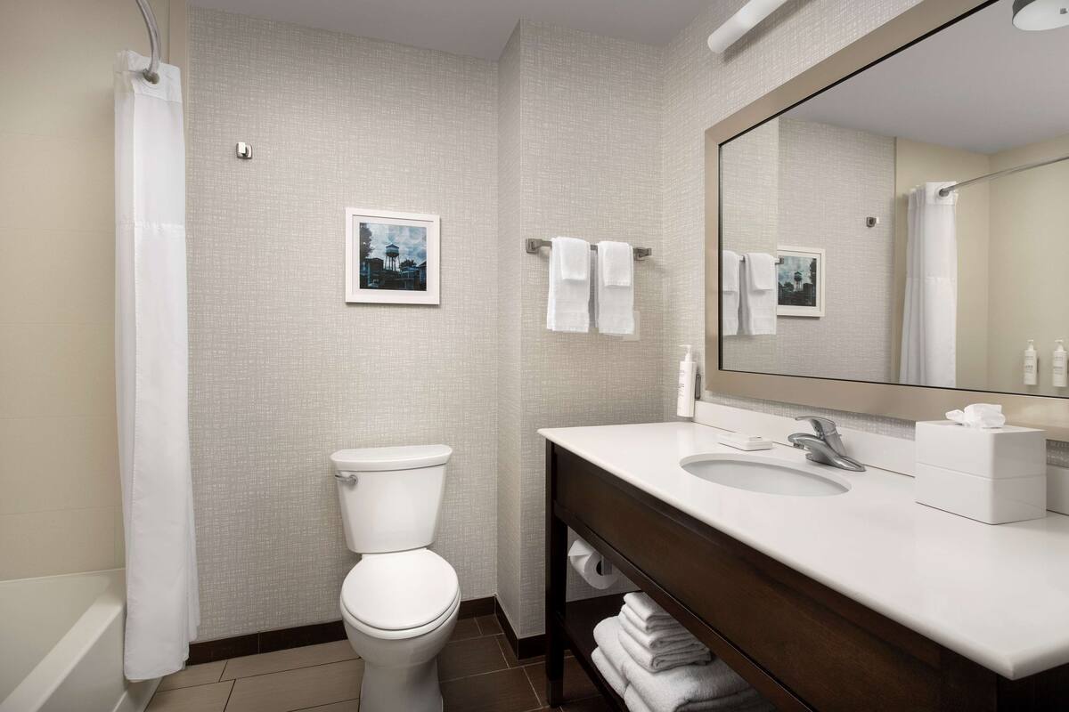 designer toiletries, hair dryer, towels, soap