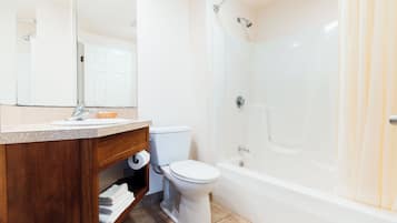 A modern bathroom with a toilet, sink, and bathtub.