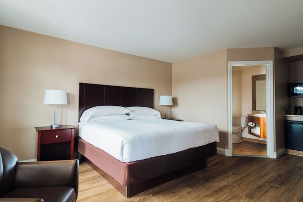 Premium bedding, desk, laptop workspace, blackout drapes