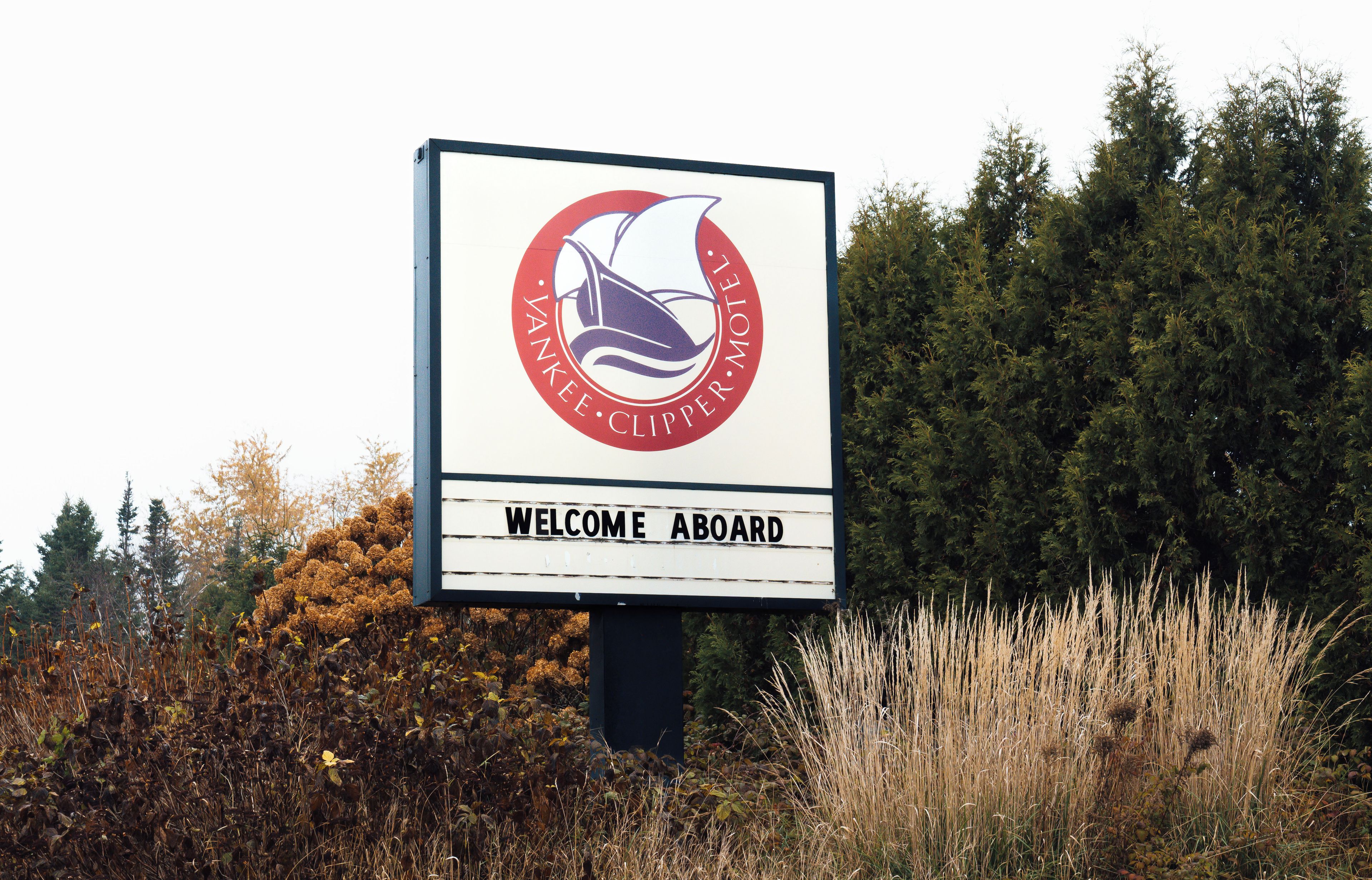 A welcome signboard for Yankeecupper motel with a logo and a message.