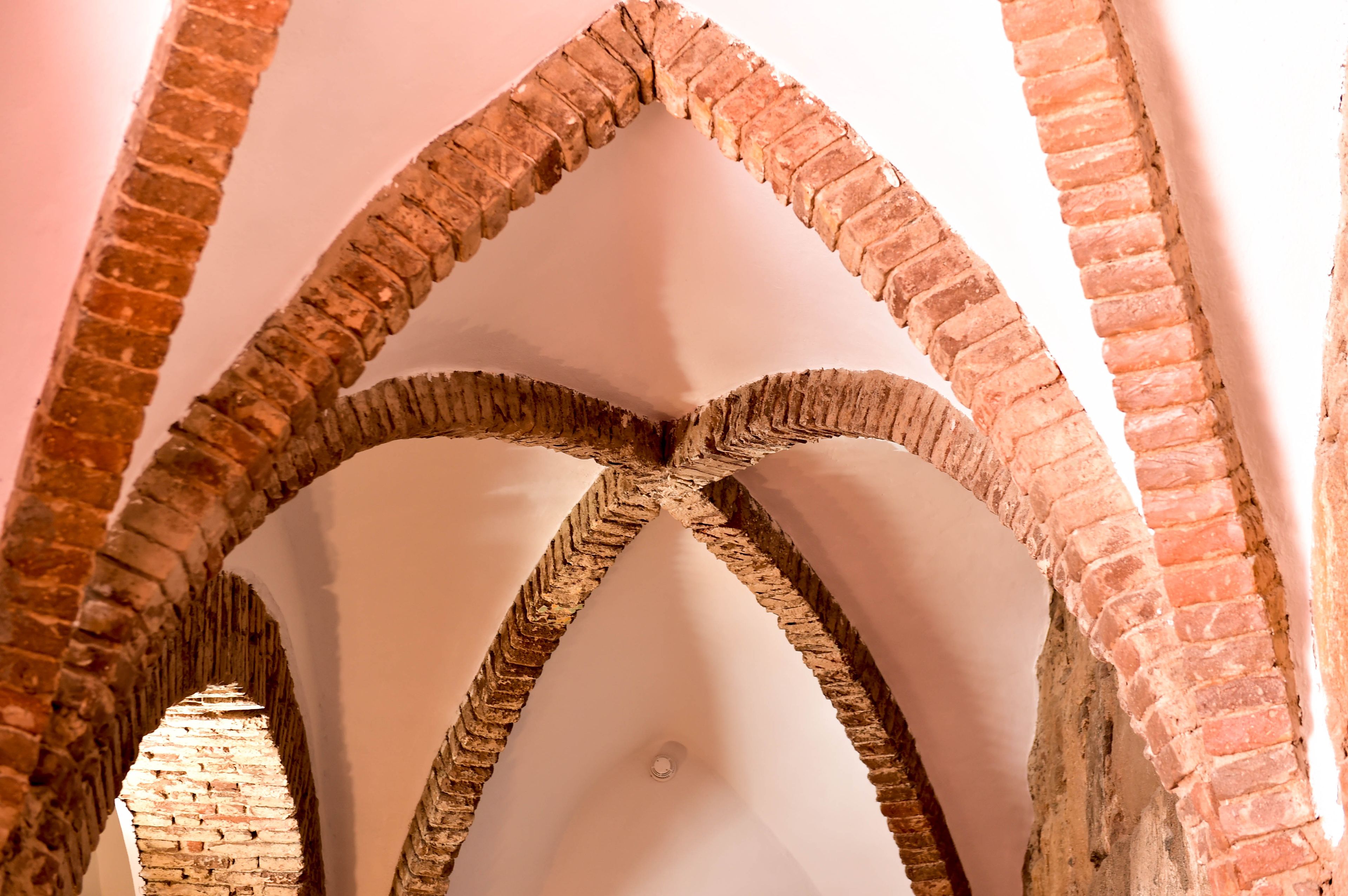 A Gothic-style archway with brickwork and pointed arches.