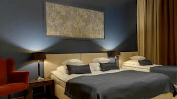 A hotel room with two beds, a red armchair, and a large abstract painting on the wall.
